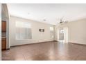Spacious living room featuring neutral paint, tile flooring, and abundant natural light at 1968 E Emily Ln, Gilbert, AZ 85295