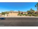 Inviting single-story home boasting lush desert landscaping and a spacious three-car garage at 19714 N Rim Dr, Surprise, AZ 85374