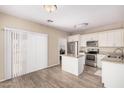 Bright kitchen with white cabinets, stainless steel appliances, and an island at 2024 E Dust Devil Dr, San Tan Valley, AZ 85143