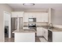 Well-lit kitchen featuring white cabinets, granite countertops, and stainless appliances at 2024 E Dust Devil Dr, San Tan Valley, AZ 85143