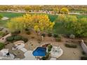 Stunning backyard view showcasing a sparkling pool, scenic green landscaping, and a charming firepit area at 22231 N 55Th St, Phoenix, AZ 85054