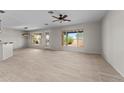 Spacious open-concept living room with tile flooring, perfect for entertaining at 22815 N Arrellaga Dr, Sun City West, AZ 85375