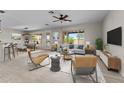 Bright and airy living room with tile floors and modern furnishings at 22815 N Arrellaga Dr, Sun City West, AZ 85375