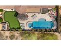 Aerial shot of luxurious backyard with pool, spa, putting green, lounge area, and outdoor fireplace at 2304 N Steele Cir, Mesa, AZ 85207