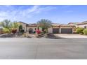 Beautiful home with an arched doorway, tile roof, desert landscaping, and a three car garage at 2304 N Steele Cir, Mesa, AZ 85207