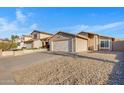 A single-story home with a two-car garage and desert landscaping offering curb appeal at 23829 N 36Th Dr, Glendale, AZ 85310