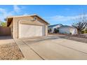 Detached garage with a wide driveway and minimalist landscaping at 23829 N 36Th Dr, Glendale, AZ 85310