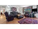 Comfortable living room with plush leather seating, a center table, and a large patterned rug at 2757 Leisure World --, Mesa, AZ 85206