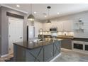 Charming kitchen with gray cabinets, wooden countertops, a kitchen island, and stainless steel appliances at 29706 N 127Th Ln, Peoria, AZ 85383