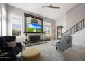 Comfortable living room featuring a fireplace, large windows, vaulted ceilings and neutral decor at 29706 N 127Th Ln, Peoria, AZ 85383