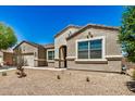 Attractive single-story home with neutral stucco, desert landscaping, and an arched entryway at 30208 W Fairmount Ave, Buckeye, AZ 85396