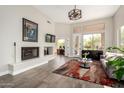 Spacious living room with a fireplace, neutral walls, and large windows with natural light at 32627 N 70Th St, Scottsdale, AZ 85266