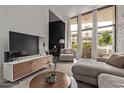 Bright living room featuring modern décor, textured walls, and views from the outdoor patio at 334 W Medlock Dr # D102, Phoenix, AZ 85013