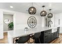 Bright kitchen features an island with seating, pendant lighting, and white countertops at 36601 N Mule Train Rd # D1, Carefree, AZ 85377