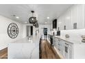 Modern kitchen with a central island, pendant lighting, and stainless steel appliances at 36601 N Mule Train Rd # D1, Carefree, AZ 85377