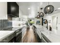 Contemporary kitchen featuring white cabinetry, stainless appliances, and a large central island at 36601 N Mule Train Rd # D1, Carefree, AZ 85377