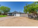 Single-story home with an expansive parking area and block wall at 3824 N 8Th Ave, Phoenix, AZ 85013