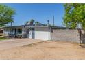Single-story home with an expansive parking area and block wall at 3824 N 8Th Ave, Phoenix, AZ 85013