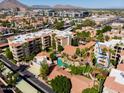 Stunning aerial view of a complex featuring lush landscaping, a refreshing pool, and well-maintained apartment buildings at 4200 N Miller Rd # 228, Scottsdale, AZ 85251