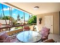 Inviting balcony features a round table and cushioned chairs, perfect for outdoor relaxation at 4200 N Miller Rd # 228, Scottsdale, AZ 85251