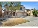 Charming two-story home featuring stucco finish, tile roof, a three-car garage, and well-maintained landscaping at 43232 W Magnolia Rd, Maricopa, AZ 85138