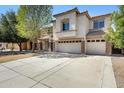 Charming two-story home featuring stucco finish, tile roof, a three-car garage, and well-maintained landscaping at 43232 W Magnolia Rd, Maricopa, AZ 85138