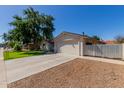Exterior view of a single-story home with attached garage and desert landscaping at 4716 W Hayward Ave, Glendale, AZ 85301