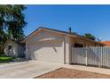 Exterior view of a single-story home with attached garage and desert landscaping at 4716 W Hayward Ave, Glendale, AZ 85301