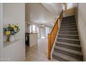 Inviting entryway with staircase, tile flooring, and open view to the kitchen and dining area at 5323 E Hopi Ave, Mesa, AZ 85206