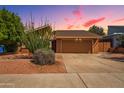 Inviting exterior with a well-maintained yard, desert foliage and spacious two-car garage at 5528 E Virginia Ave, Phoenix, AZ 85008