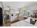 Open-concept kitchen features stainless appliances, stone tile flooring, and ample counter space at 5528 E Virginia Ave, Phoenix, AZ 85008