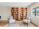 Inviting sitting room with natural light, hardwood floors, and bookshelves at 5738 N 34Th S Dr, Phoenix, AZ 85017