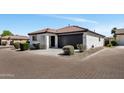 Charming single-story home with a black garage door and low maintenance landscaping at 6108 S Wilson Dr, Chandler, AZ 85249