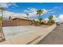 Lovely home with a two-car garage, spacious driveway and low maintenance desert landscaping at 6128 E Portia St, Mesa, AZ 85215