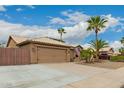 Attractive home with a two-car garage, gated RV parking, and desert landscaping at 6128 E Portia St, Mesa, AZ 85215