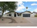 Charming home with stucco exterior, rock landscaping and a two car garage at 6228 E Blanche Dr, Scottsdale, AZ 85254