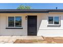 The front of the house features a stylish black steel security door framed by windows at 6733 N 49Th Ave, Glendale, AZ 85301