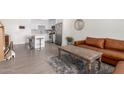 Open-concept living space featuring a kitchen island, hardwood floors, and a cozy seating area at 7300 E Earll Dr # 1022, Scottsdale, AZ 85251