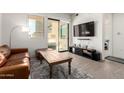 Inviting living room with a large flat screen TV, a balcony, and comfortable seating at 7300 E Earll Dr # 1022, Scottsdale, AZ 85251