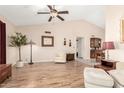 Bright living room with hardwood floors, vaulted ceilings, and comfortable seating at 7515 W Sweetwater Ave, Peoria, AZ 85381