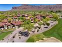 Aerial view of a home with a red tile roof surrounded by desert landscaping and a golf course at 7780 E Golden Eagle Cir, Gold Canyon, AZ 85118
