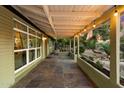 Side covered porch with slate tile flooring and decorative hanging lights at 7813 N 17Th Dr, Phoenix, AZ 85021
