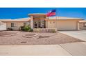 Charming front yard featuring desert landscaping, charming curb appeal, and an American flag at 8037 E Navarro Ave, Mesa, AZ 85209