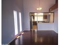 Dining room with three light windows, and hardwood flooring that leads to the kitchen at 8310 N 49Th Ave, Glendale, AZ 85302