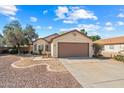 Single car garage with tan home and desert landscaping at 8335 W Pershing Ave, Peoria, AZ 85381