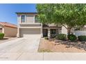 Charming two-story home featuring a well-maintained yard, mature tree, and a two-car garage at 852 E Mountain View Rd # 18, San Tan Valley, AZ 85143