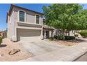 Charming two-story home featuring a well-maintained yard, mature tree, and a two-car garage at 852 E Mountain View Rd # 18, San Tan Valley, AZ 85143