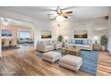 Bright living room with hardwood floors, neutral furniture, ceiling fan, and views to dining and another living space at 858 S Portland --, Mesa, AZ 85206