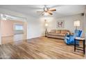 Spacious living room showcasing hardwood floors and neutral walls, complemented by ceiling fans at 858 S Portland --, Mesa, AZ 85206