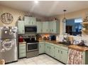Traditional kitchen featuring stainless steel appliances and ample counter space with tiled backsplash at 9327 E Des Moines St, Mesa, AZ 85207
